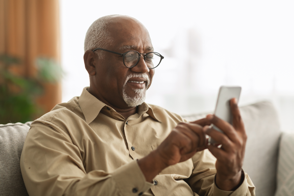 man using mobile phone on couch